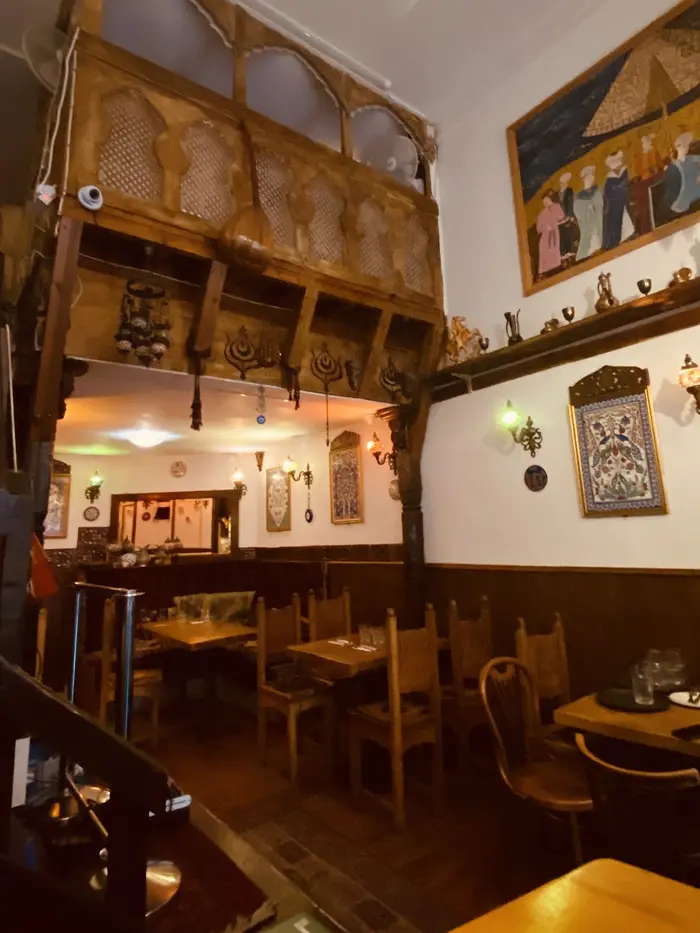 Carved wooden mezzanine with Ottoman arches and a miniature painting